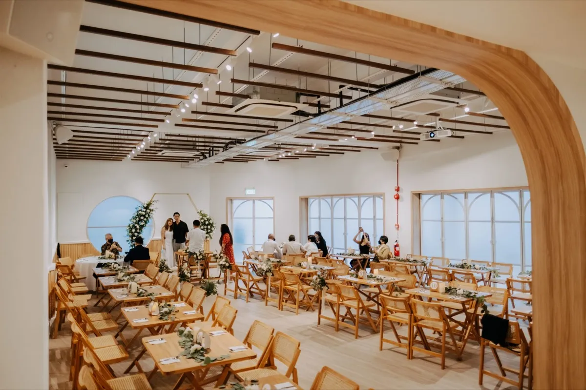 HAUS217 interior with warm wood, arched windows, and wedding table setup